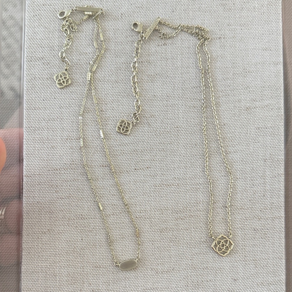 X2 Kendra Scott gold logo necklaces